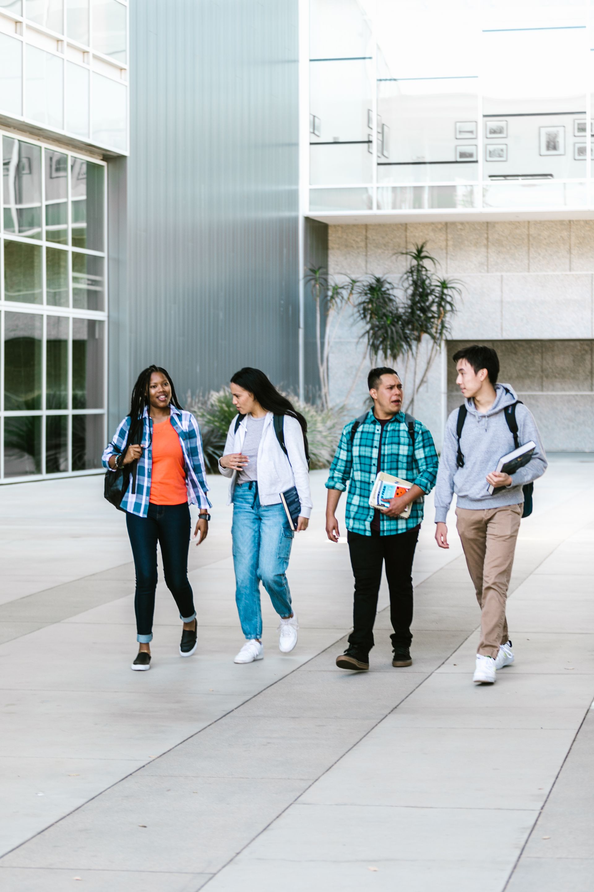 A group of college students walking together on a modern campus