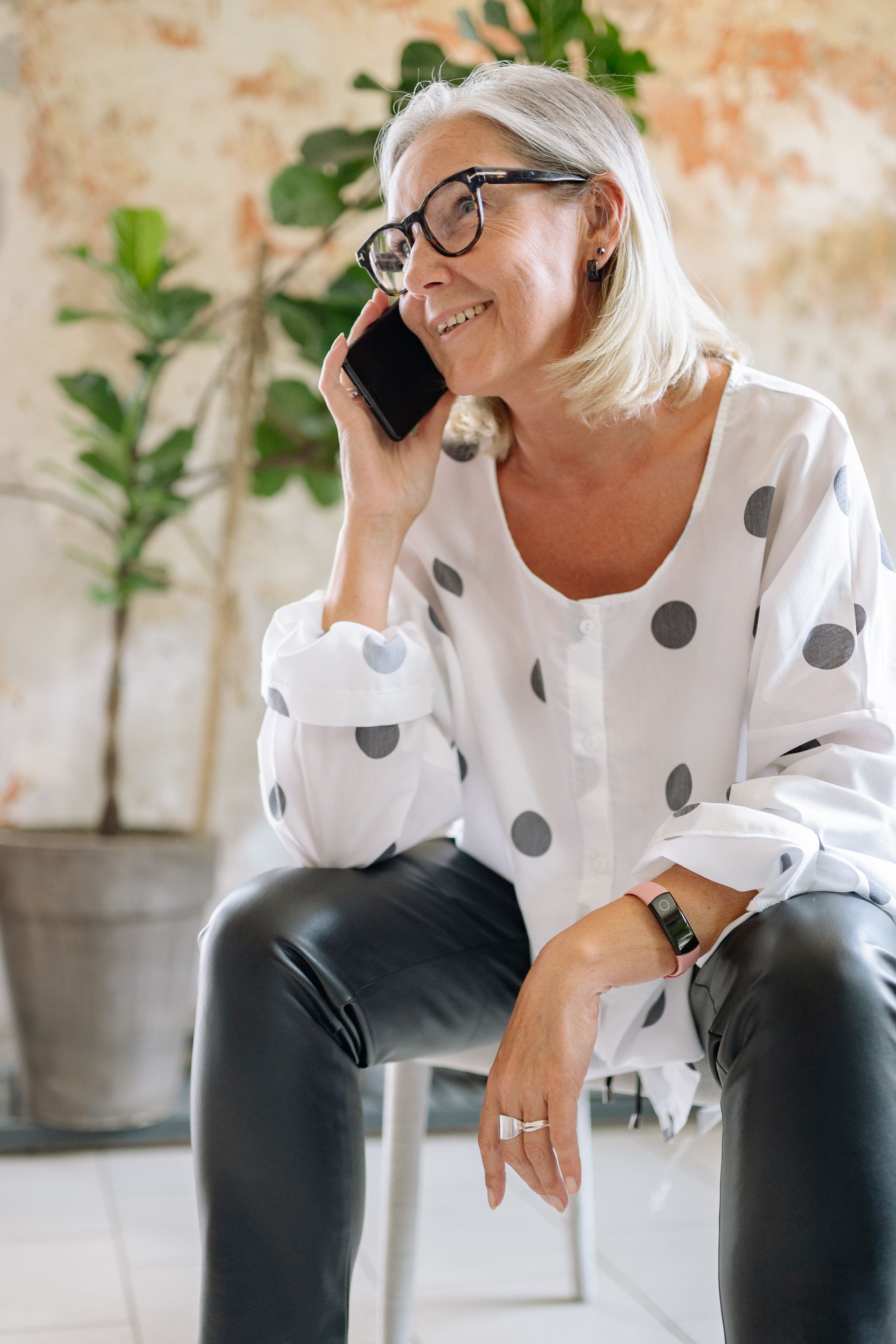 A parent smiles with visible relief while on a phone call, finally getting an honest answer.