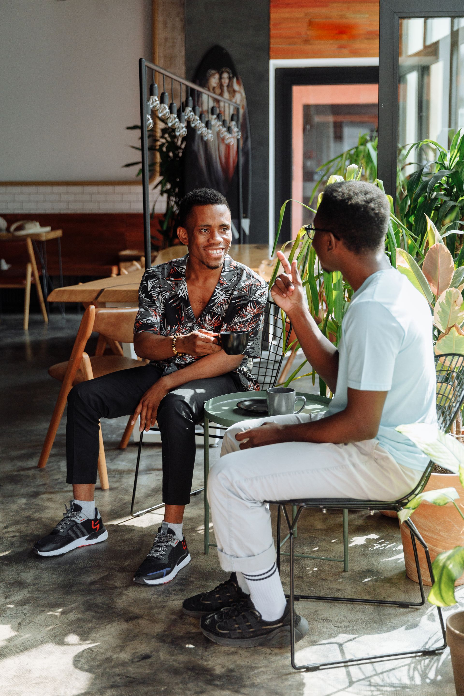 Two men in an unhurried conversation over coffee